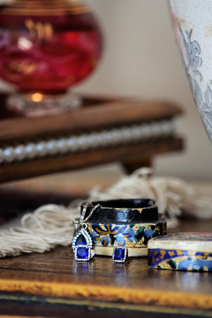 Close-up of luxurious blue gemstone jewelry set in ornate boxes, showcasing elegance and craftsmanship.